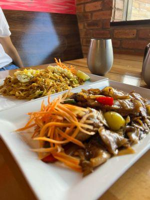 Pad Kee Mao (sometimes referred to as drunken noodles) and Pad Thai in the back - both delicious!