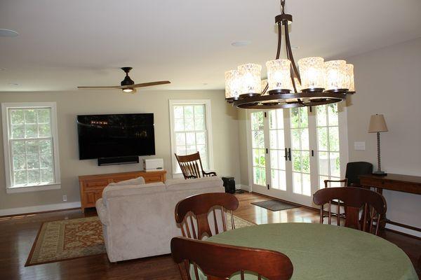 Featured here: 12 light chandelier with Venetian glass and 60" ceiling fan with buttonwood blades and an app to control the light and speed.