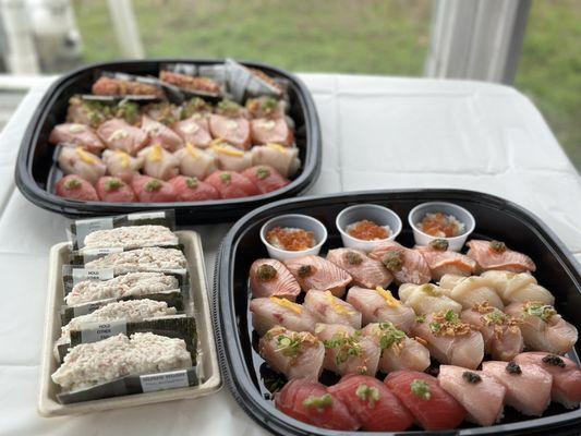 Deluxe party platter (bottom right), party platter and California rolls.