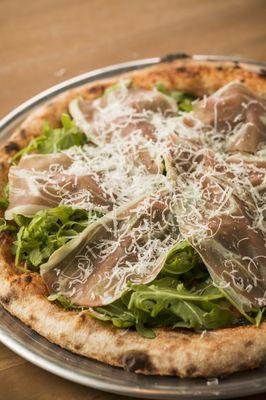 Prosciutto Pizza: Tomato sauce, Mozzarella, local arugula, and shaved Grana Padano cheese.