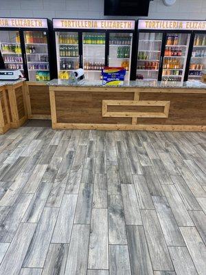 Clean checkout area with variety of Hispanic drinks