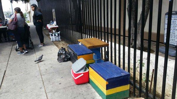 Benches on the sidewalk for sitting.