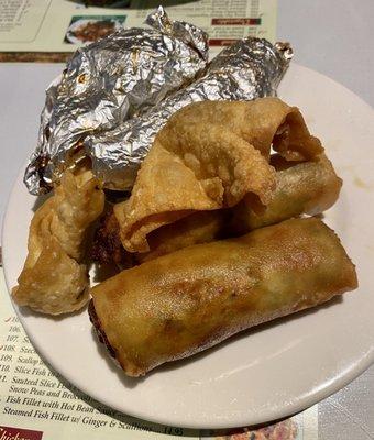 Appetizers egg rolls,fried wontons, and paper wrapped chicken.