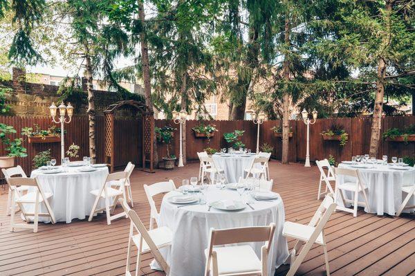 Our lush outdoor patio is nestled between towering pine trees creating a little oasis perfect for small weddings and gatherings.