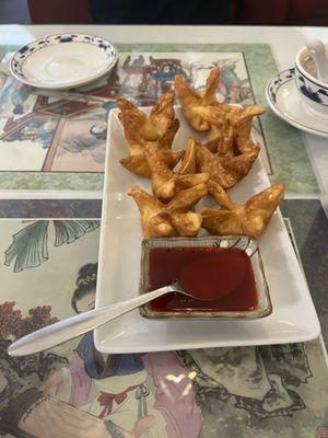 Crab and cream cheese wontons ( fried ) with sweet sauce. Such cute dishwear too !