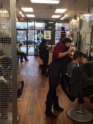 Tashia finishing up a guest fresh new haircut.