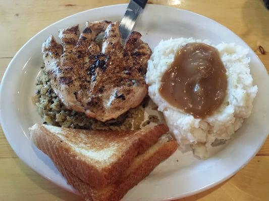 A grilled chicken breast w mashed potatoes and rice