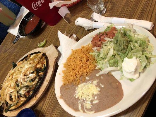 Cheesy Poblano Fajitas w beef, chicken and Shrimp. The onions are like candy so we always ask for extra!