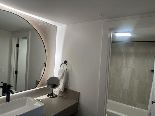 Newly renovated bathroom with private vanity and sink area separated from bathroom