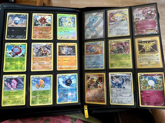 My growing collection of foiled Pokemon cards purchased at Wii Play Games.