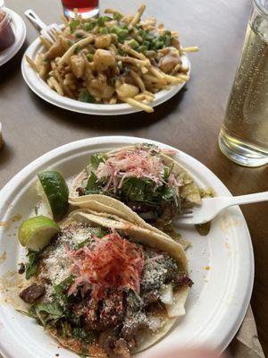 Carne asada tacos and poutine.