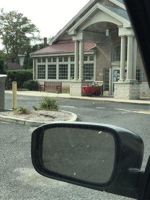 Back side of the library where the parking lot and socially distant pickup table is