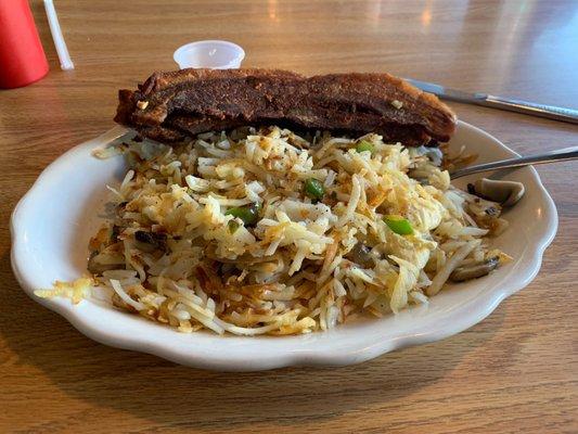 Double hash browns with onions, peppers and mushrooms along with thick cut bacon.