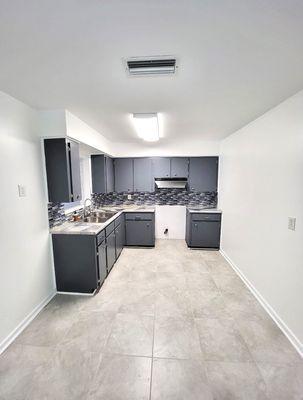 After Kitchen:
Ceramic Tile, Custom Epoxy Countertops, Backsplash and fresh pain opened this kitchen up