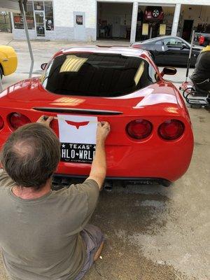 Action shot of Chris applying my rear emblem.