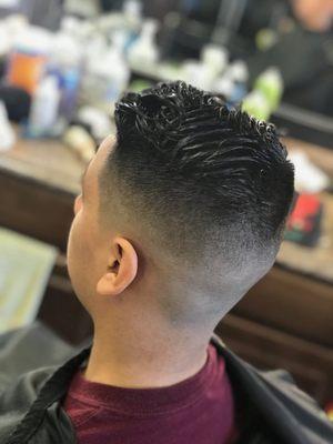 Mid skin fade with a style top.