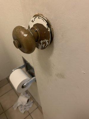 Bathroom door knob half hanging off