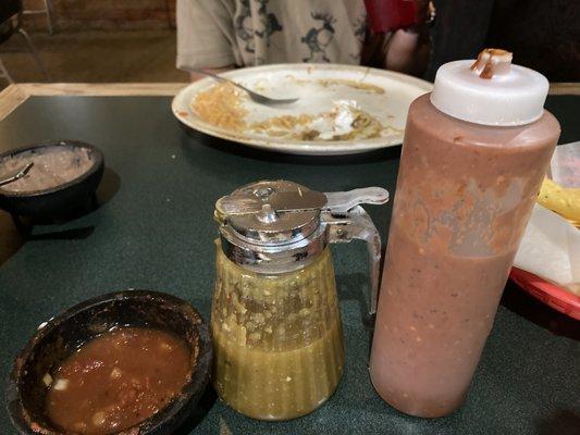 Three options for salsa. the default red mild sauce, medium green sauce and a spicy red sauce