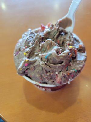 Chocolate silk ice cream with rainbow sprinkles and strawberries