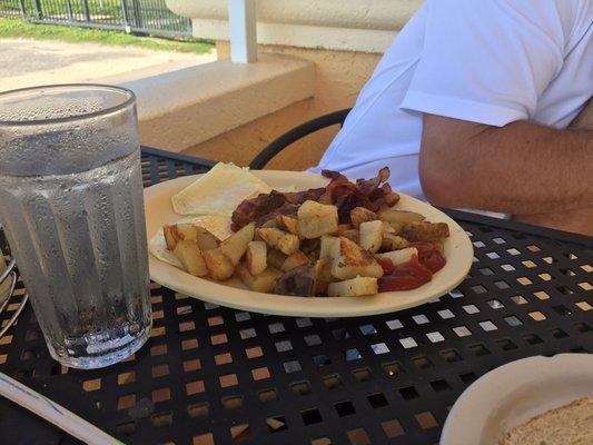 Two egg breakfast with crispy bacon and home fries