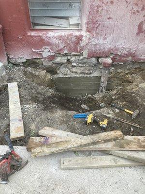 Foundation sandstone repair below sidewalk grade