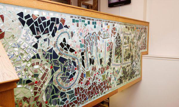 Isaiah Zagar, the artist famous for the Magic Gardens on South Street, also created this Smile mural in our office.