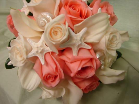 Bridal bouquet of coral and ivory's with star fish and sea shells