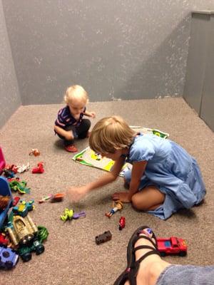 Small enclosed area for kids to play while parents wait on car service.