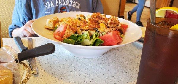 A huge grilled chicken Caesar salad.