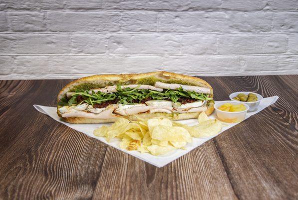 Lucca: turkey, dried tomato, fresh mozzarella, arugula and basil pesto
 (Includes chips and drink)