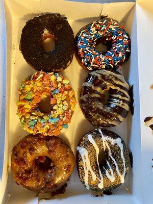 Cookies and cream, chocolate sprinkle, fruity pebbles, chocolate peanut butter drizzle, maple bacon, and s'mores.