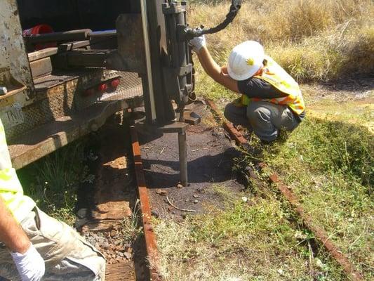 Subsurface soil sample collection at abandoned railroad tracks.