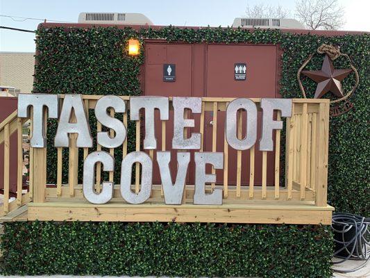 Taste of Cove sign and restroom facilities.