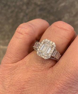 Emerald cut center stone in custom setting