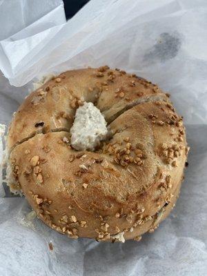 Garlic bagel toasted with tuna salad and onion