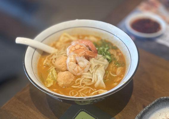 A1. Signature Trio Shrimp Noodle: prawn, ebiko prawn ball, prawn & chicken wonton, 8-hour shrimp broth, cabbage & green onion | $18.95