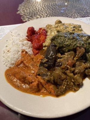 Clockwise from rice is chili chicken, mushroom curry, saag paneer, eggplant, curry chicken and butter chicken