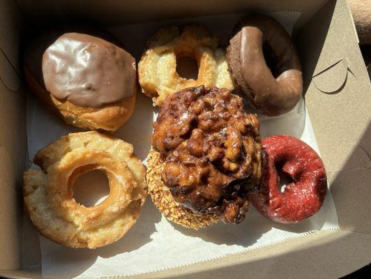 Cream filled, old-fashioned sour cream, chocolate iced chocolate, apple fritter (maple peanut underneath), red velvet.