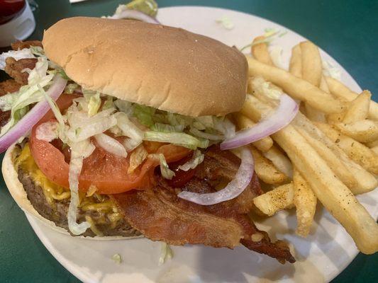 Loaded burger with bacon and fries.