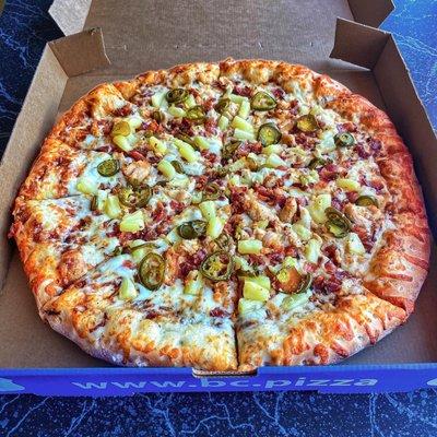 BBQ pizza, chicken, bacon, jalapeños, and pineapple