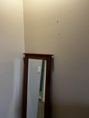 Mirror not mounted to wall.