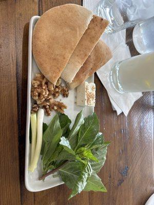 Complementary starter plate with meal purchase. Warm pita, feta, walnuts, onion and herbs. A perfect start for an Iranian meal.