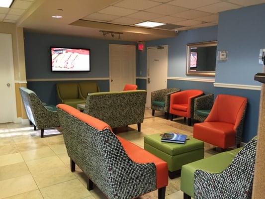 Newly remodeled and redecorated waiting room 2 with large screen TVs and ipads for your comfort.