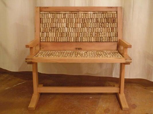 Two-seater bench made from 2 old windows and upholstered with wine corks!