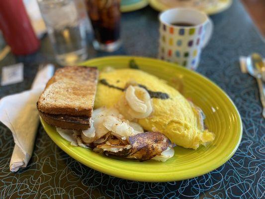 Vegetarian omelette, breakfast potatoes, and wheat toast.