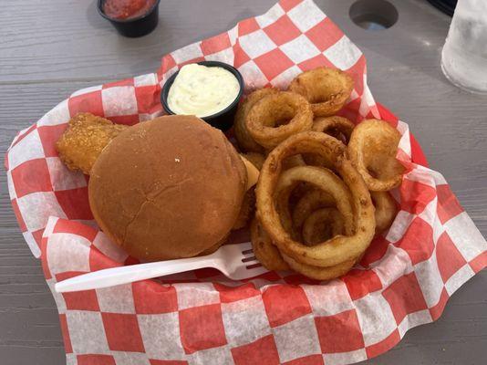 Cod fish sandwich with onion rings.