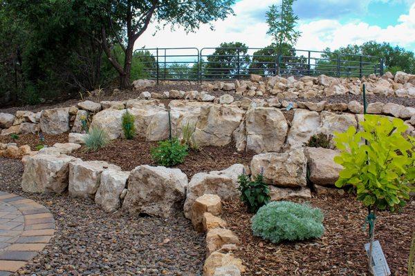 Rock retaining walls, low-water use plantings,