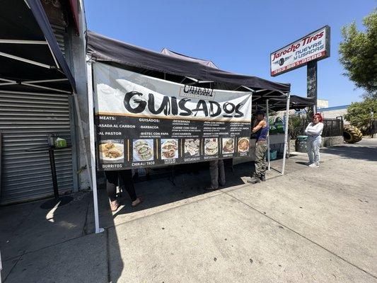 In front of the stand with the menu