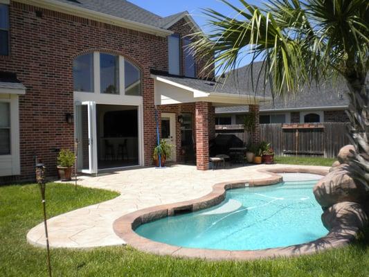 Pool with waterfall and slide. Also a custom folding door system.