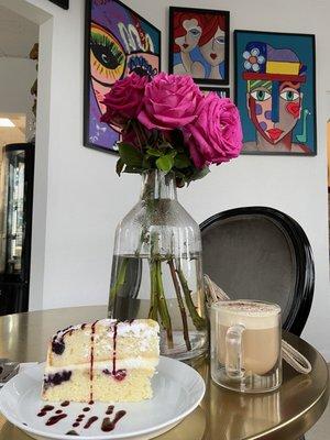 Beautiful, delicious cake, strong delicious cappuccino and artwork! The atmosphere is so great!